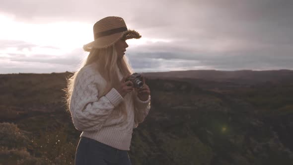 Woman In Straw Hat Using Vintage Camera In Iceland