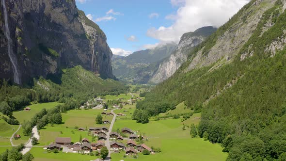 Flying a drone from right to left in the beautiful valley of lauterbrunnen in switzerland. It looks