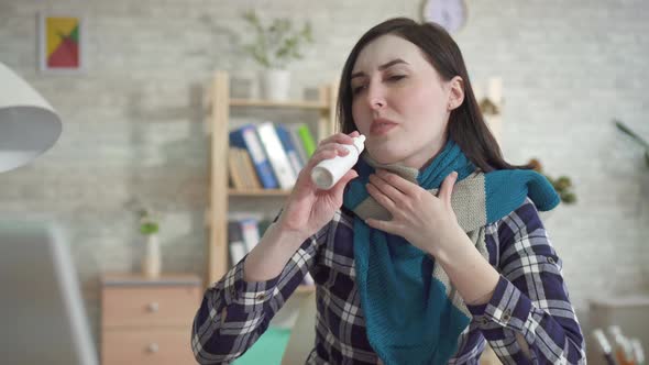 Young Woman Working in the Office Has a Sore Throat