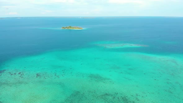 Aerial: flying over coral reef caribbean sea turquoise water, exotic tropical islands