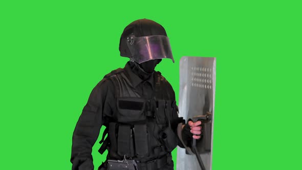 Riot Police Unit in Armor Baton Protective Shield Walking on a Green Screen Chroma Key