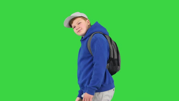 Boy Walking By and Making Hello Gesture To Camera on a Green Screen Chroma Key