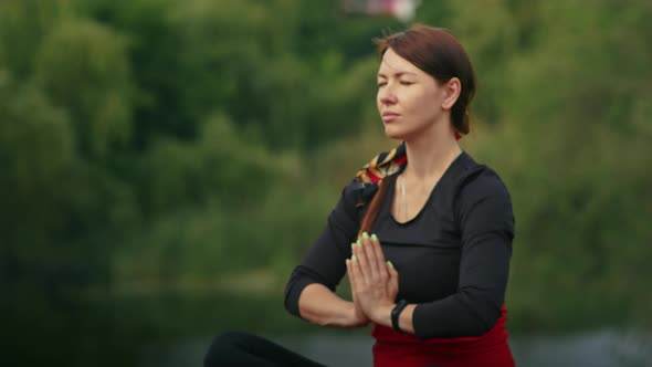 Happy Young Woman Doing Yoga Outdoors