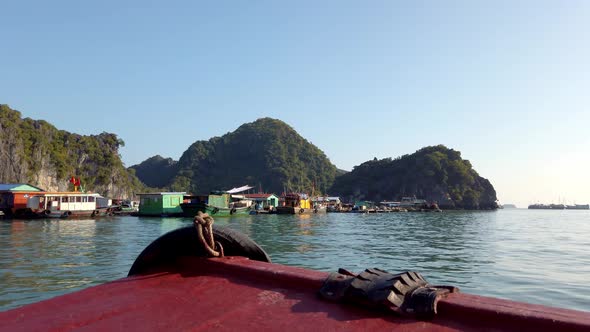 Approaching boats parked on Ha Long Bay Vietnam on the deck of a small vessel, Handheld stable shot