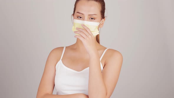 Young happy Asian woman wearing hygienic mask to prevent infection corona virus