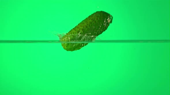 Super Slow Motion One Cucumber Falls Into Water with Splashes