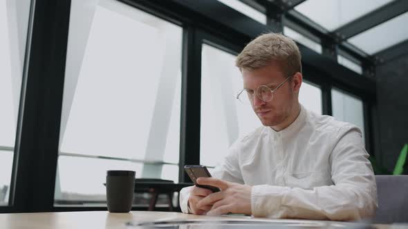 Pathological Internet Use and Doomscrolling of Modern People Handsome European Man is Reading News