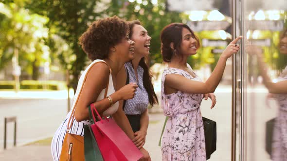 Women with Shopping Bags Looking at Shop Window 19