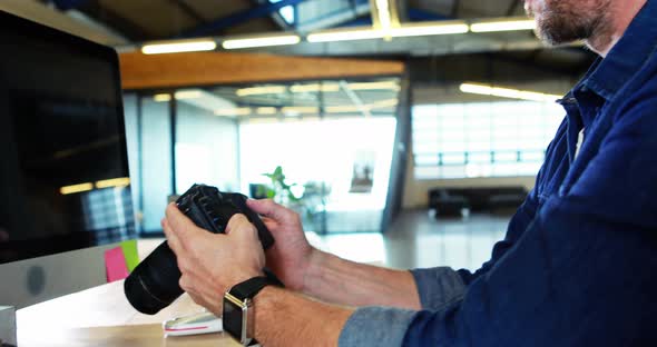 Man checking photos in camera