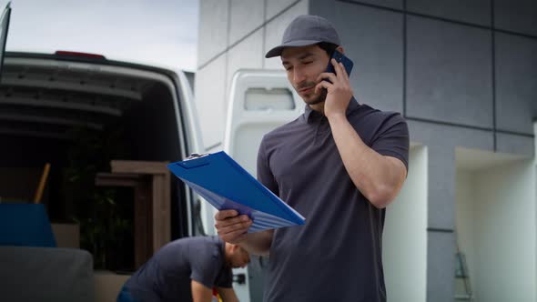 Handheld video of delivery man calling a customer. Shot with RED helium camera in 8K.