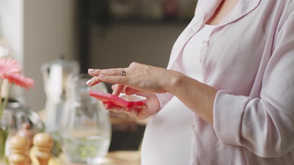 Pregnant Woman Taking Pills at Home