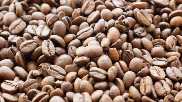 Many coffee beans food and drink  background  slow tilt 4K 2160p 30fps UHD video - Slow tilting over
