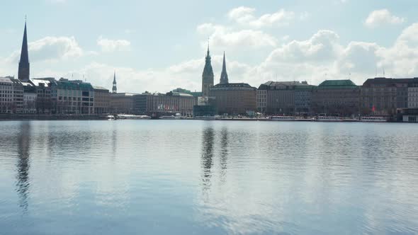 Flying Over Water Surface of Binnenalster Lake Towards Hamburg City Center with Town Hall