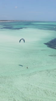 Vertical Video Kitesurfing Near the Shore of Zanzibar Tanzania