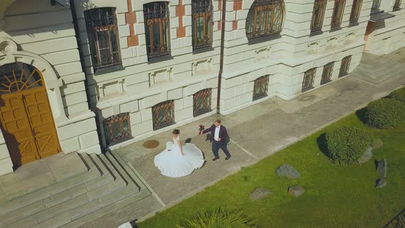 Bride Dances Spinning Near Groom By Building Upper View