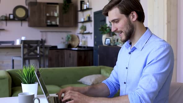 Side view happy young businessman is analizing financial documents from home during self isolation