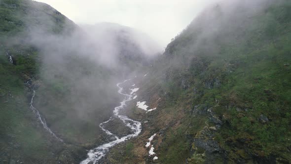 Aerial Flying Through Mist In Green Ravine At  Hardangervidda National Park, Eidfjord, Norway. Dolly