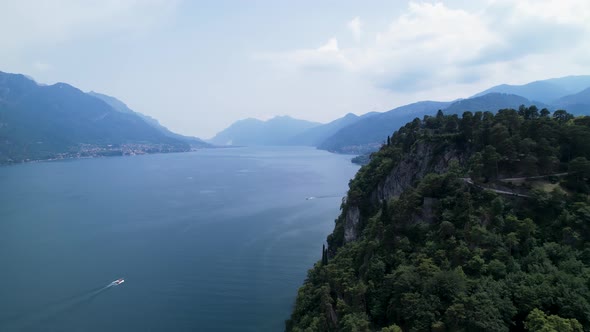 Aerial View Of Speedboat Going Across Lake Como. Dolly Left From Green Hilltop
