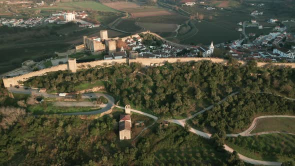 Scenic View At Castle Of Obidos On The Hilltop And Historical Village In Portugal. - Aerial Drone Sh