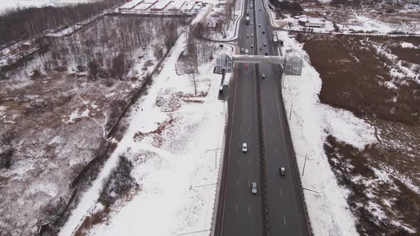 Country Highway with Cars and an Elevated Pedestrian Crossing in Winter
