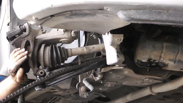 Mechanic Repairs Car Undercarriage