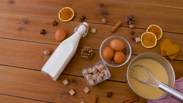 Pot with Eggnog, Ingredients and Spices on Wood