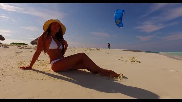 Single lady posing on tranquil resort beach holiday by blue ocean and white sand background of the M