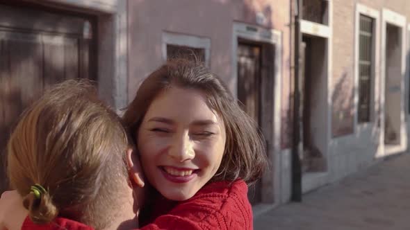 Pretty Asian Woman Rushing Into the Arms of Her Beloved Man in the Narrow Venetian Street 