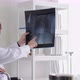 Male doctor holding x-ray film, talking, diagnosing female patient. - VideoHive Item for Sale