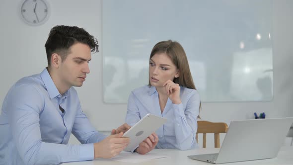 Business Colleague Discussing and Sharing Idea of New Project on Tablet