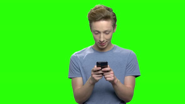 Teenage Boy Playing Video Games on Smartphone