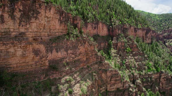 4K Aerial Drone Footage Of Large Rocky Cliff Near Alpine Forest Near Colorado River In Glenwood Cany
