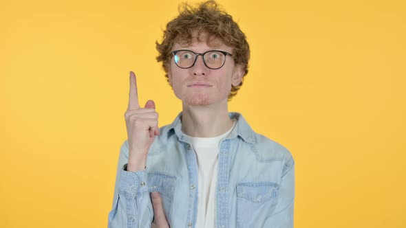 Redhead Young Man Thinking Getting Idea, Yellow Background 