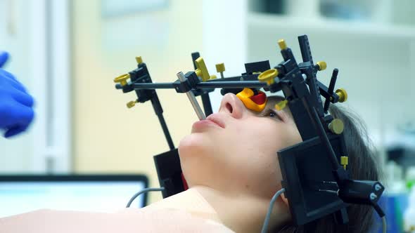 Orthodontist is Doing Condylography Procedure Examining Mandibular Joints