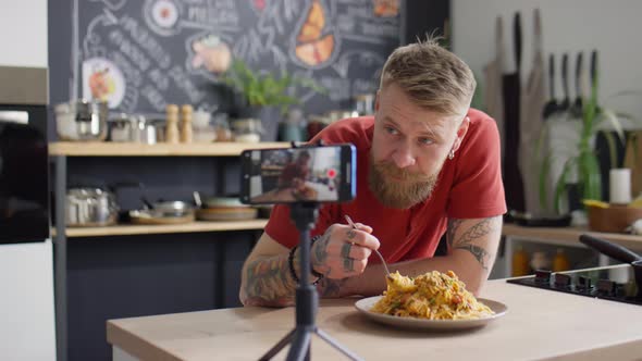 Food Blogger Eating Spaghetti and Talking on Camera