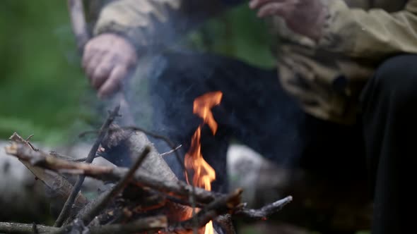 Halt in Woodland Aged Man is Resting During Trekking in Forest Sitting Near Fire with Cup of Tea