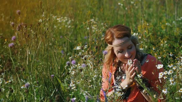 Portrait of Blonde Hippie Dancing in a Field with Flowers