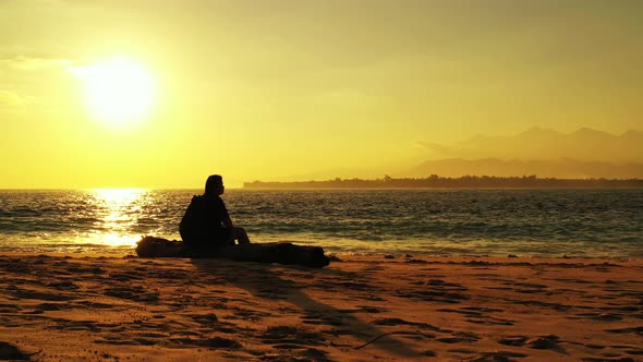 Pretty beauty model on holiday in the sun on beach on sunny blue and white sand 4K background