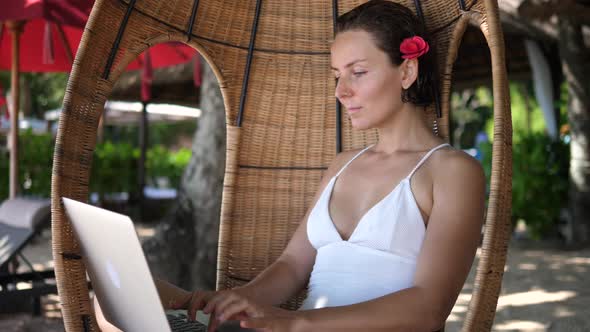 Digital Nomad Concept  White Female Working on Her Laptop From a Beach