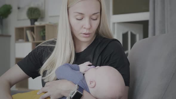 Mother Holding And Lulling Her Newborn Son