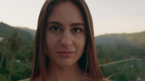 Portrait of Young Woman in Outdoor Looking at Camera