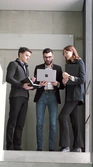 Three Coworkers Working on a Project at Office