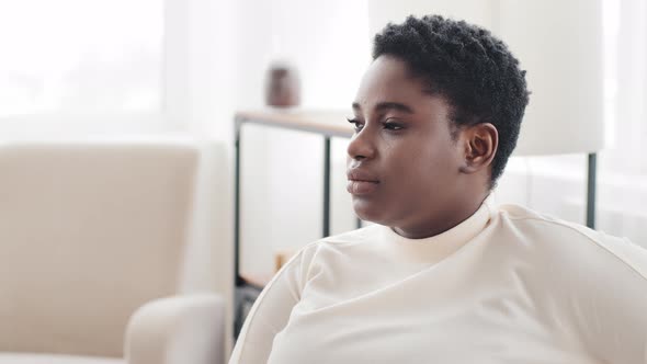 Closeup Pensive Female Face with Dark Skin in Profile