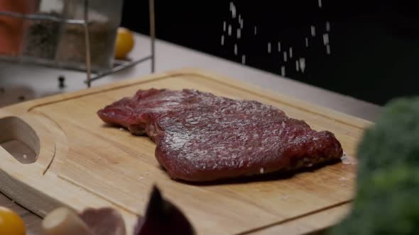 Professional Chef Salting Meat Steak