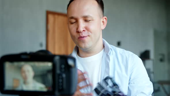 Guy blogger cyborg with bio hand prothesis conducts online stream