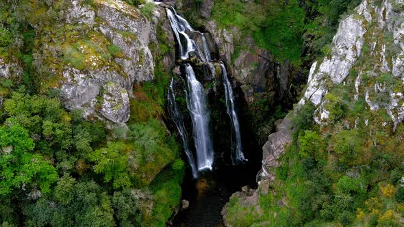 Aerial View Of Fervenza do Toxa Waterfalls Cascading Down Rockface. Pedestal Up