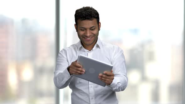 Emotional Businessman Playing Game on Digital Tablet.