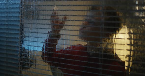 Boy Watching Storm Through Window