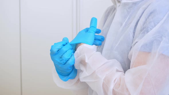 A Doctor Puts on Gloves Before Working in a Covid Hospital with Infected Patients