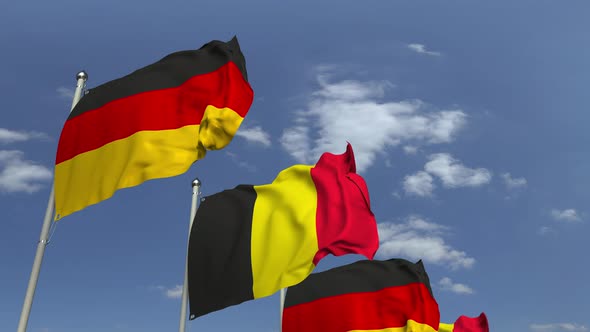 Flags of Belgium and Germany Against Blue Sky alt